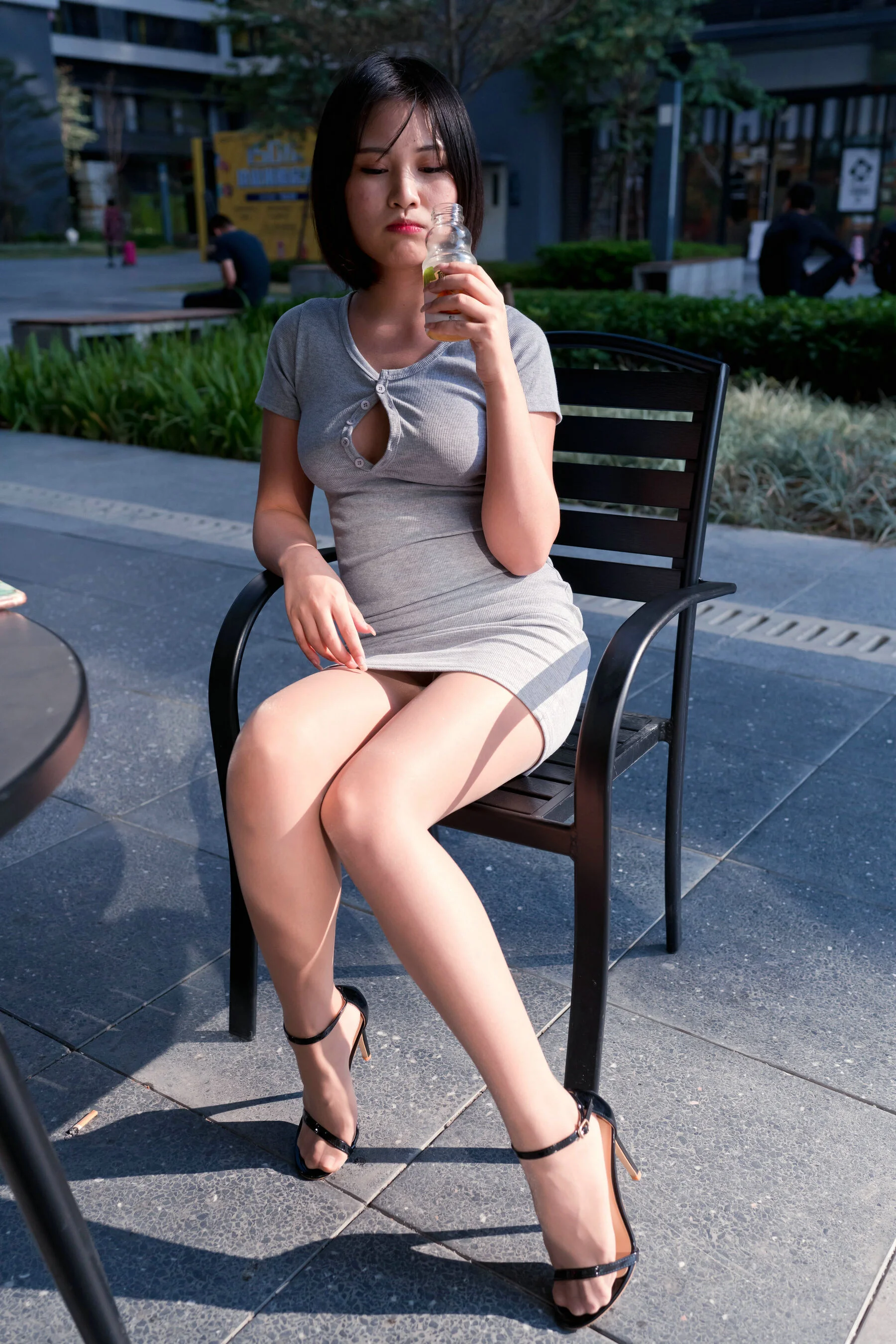 A cute baby in a bodycon skirt and stockings looking at the funhouse mirrors in the shopping plaza. (Magic Mirror Street Photography)